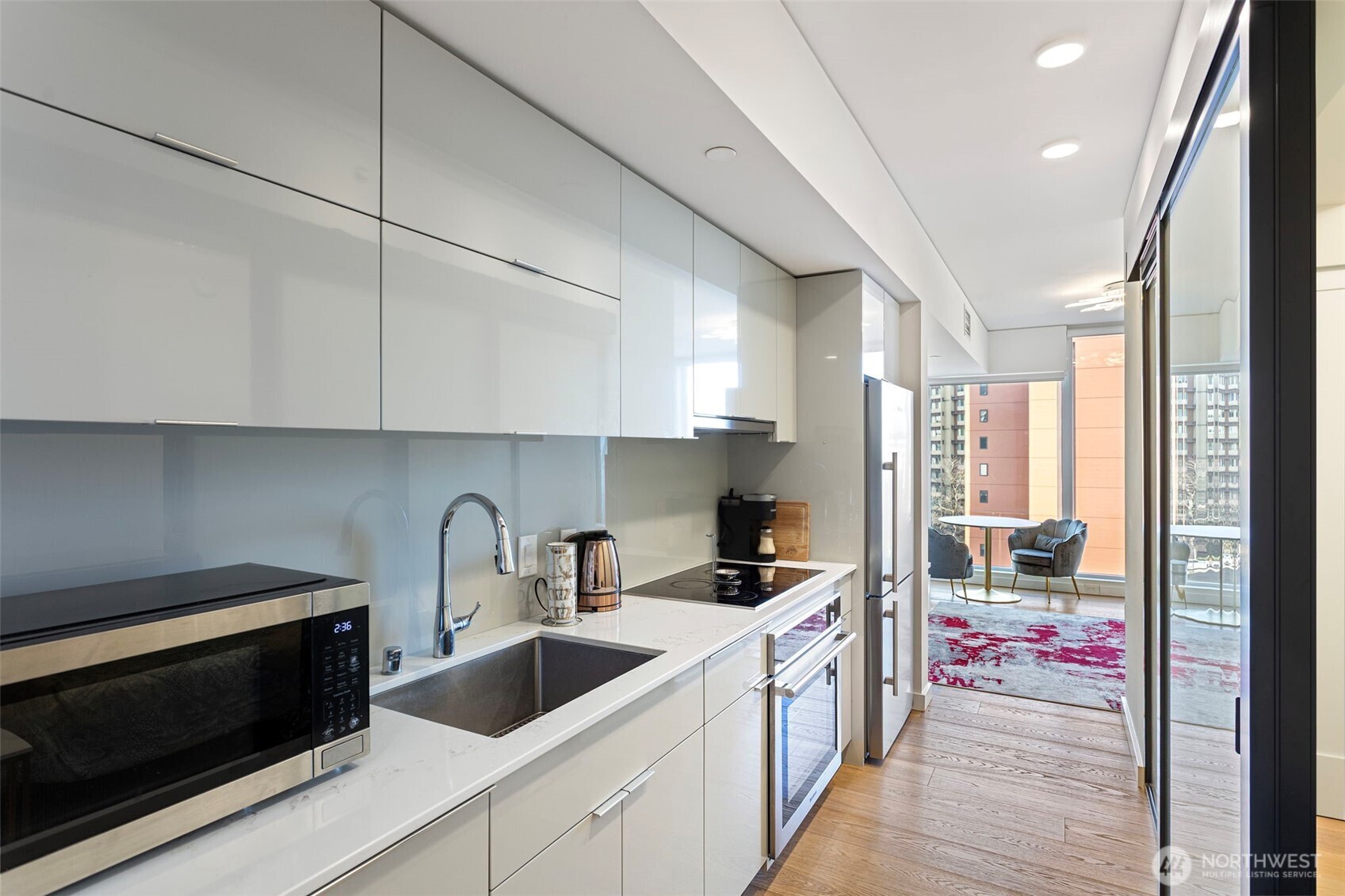 450 South Main Street, Unit 1005 Seattle, WA 98104 - Photo 28 of 33 a kitchen with a sink cabinets and window
