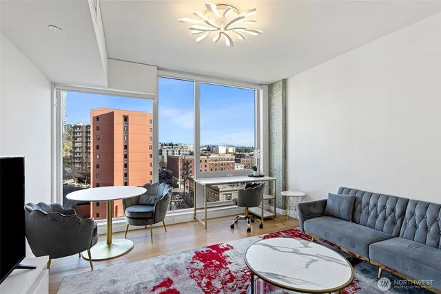 a living room with a flat screen tv and rug