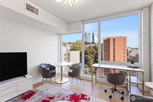 a living room with a couch and a chandelier
