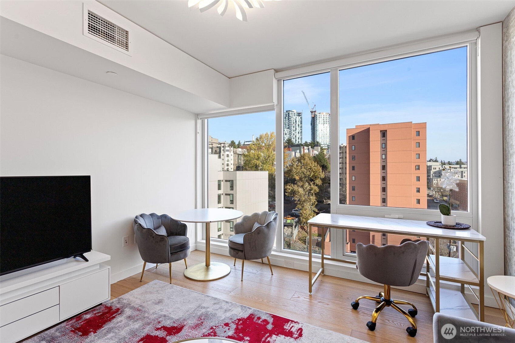450 South Main Street, Unit 1005 Seattle, WA 98104 - Photo 31 of 33 a living room with furniture and a flat screen tv