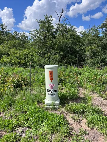 a sign board with tall trees
