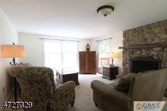 6 Pleasant View Road Lebanon, NJ 08833 - Photo 8 of 24 a living room with furniture a flat screen tv and a fireplace