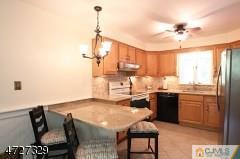 6 Pleasant View Road Lebanon, NJ 08833 - Photo 9 of 24 a kitchen with stainless steel appliances granite countertop a sink stove and refrigerator