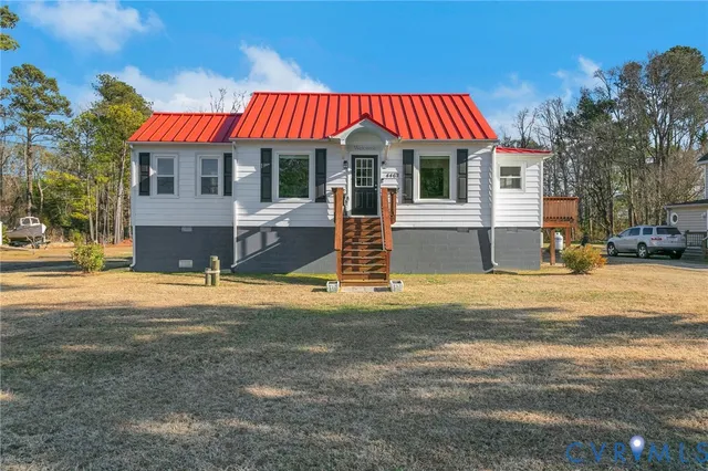 a front view of a house with a yard patio and fire pit