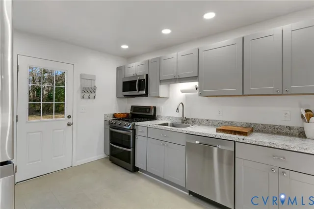 a kitchen with a sink stove and microwave