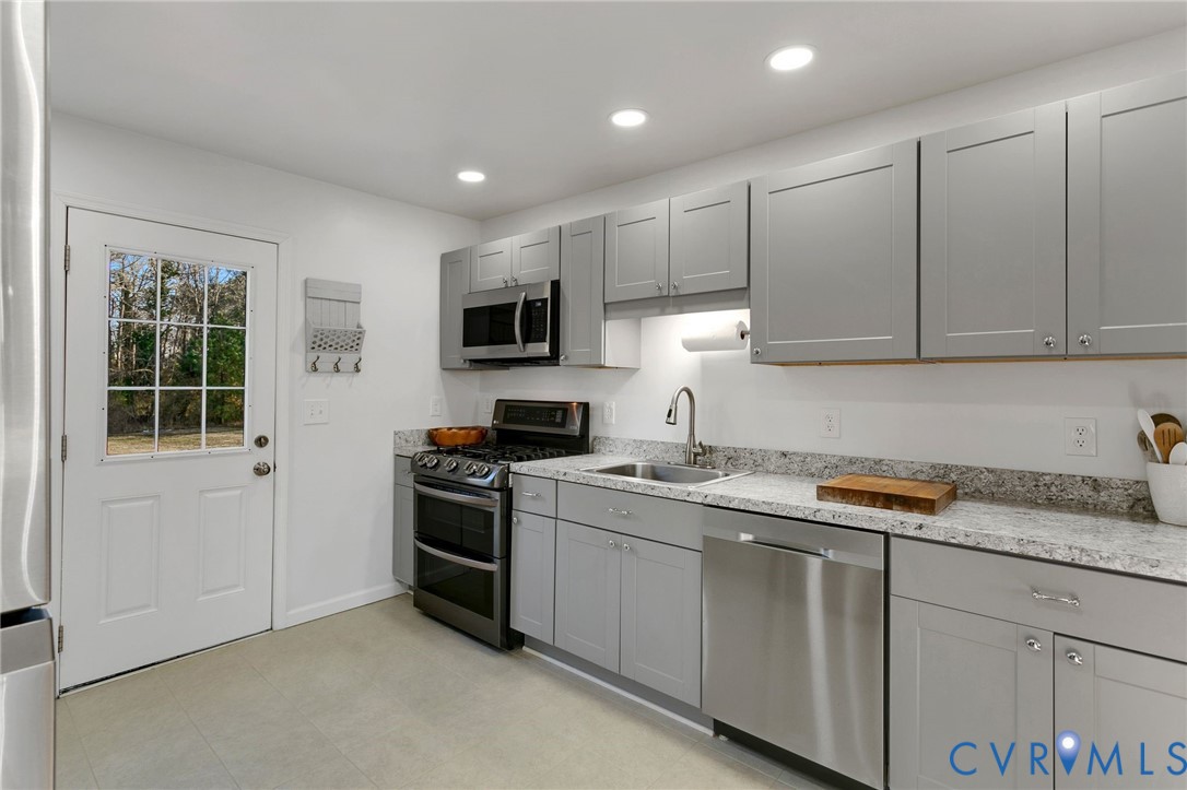 4462 Windmill Point Road White Stone, VA 22578 - Photo 13 of 29 a kitchen with a sink stove and microwave