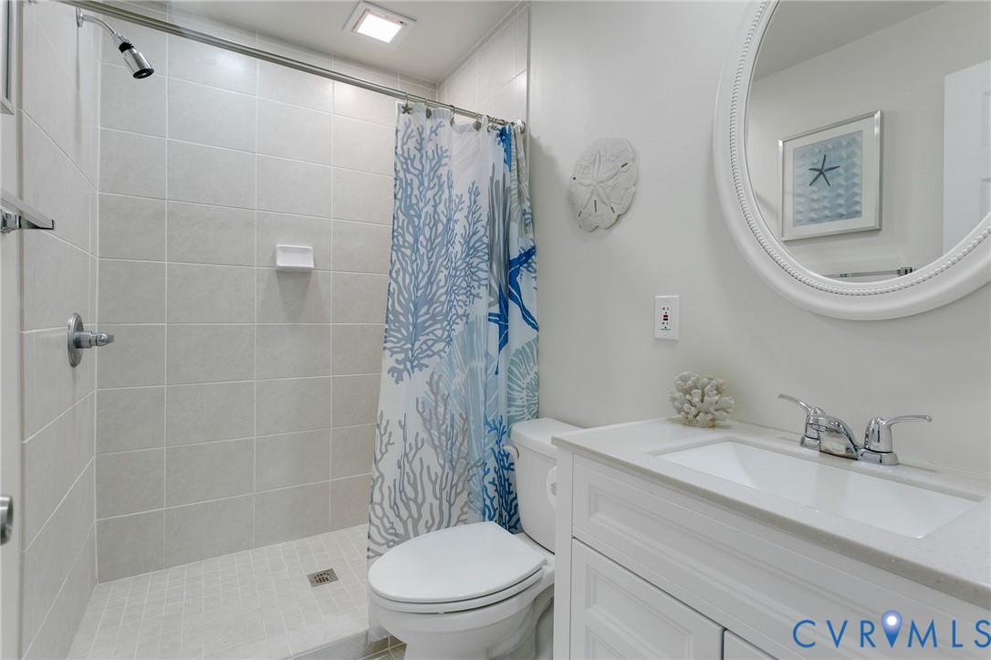 4462 Windmill Point Road White Stone, VA 22578 - Photo 16 of 29 a bathroom with a sink a toilet and shower