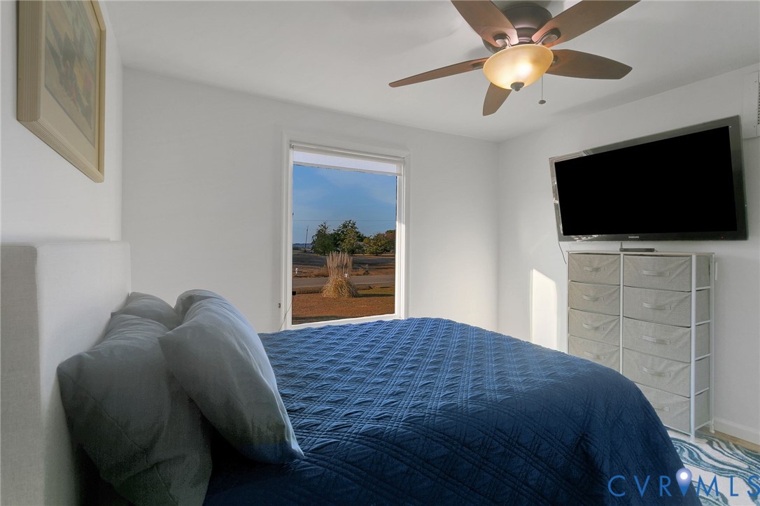 4462 Windmill Point Road White Stone, VA 22578 - Photo 17 of 29 a bedroom with a bed and a flat screen tv