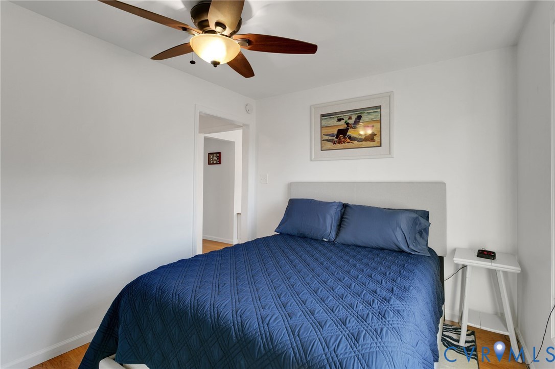 4462 Windmill Point Road White Stone, VA 22578 - Photo 18 of 29 a bedroom with a bed and a ceiling fan