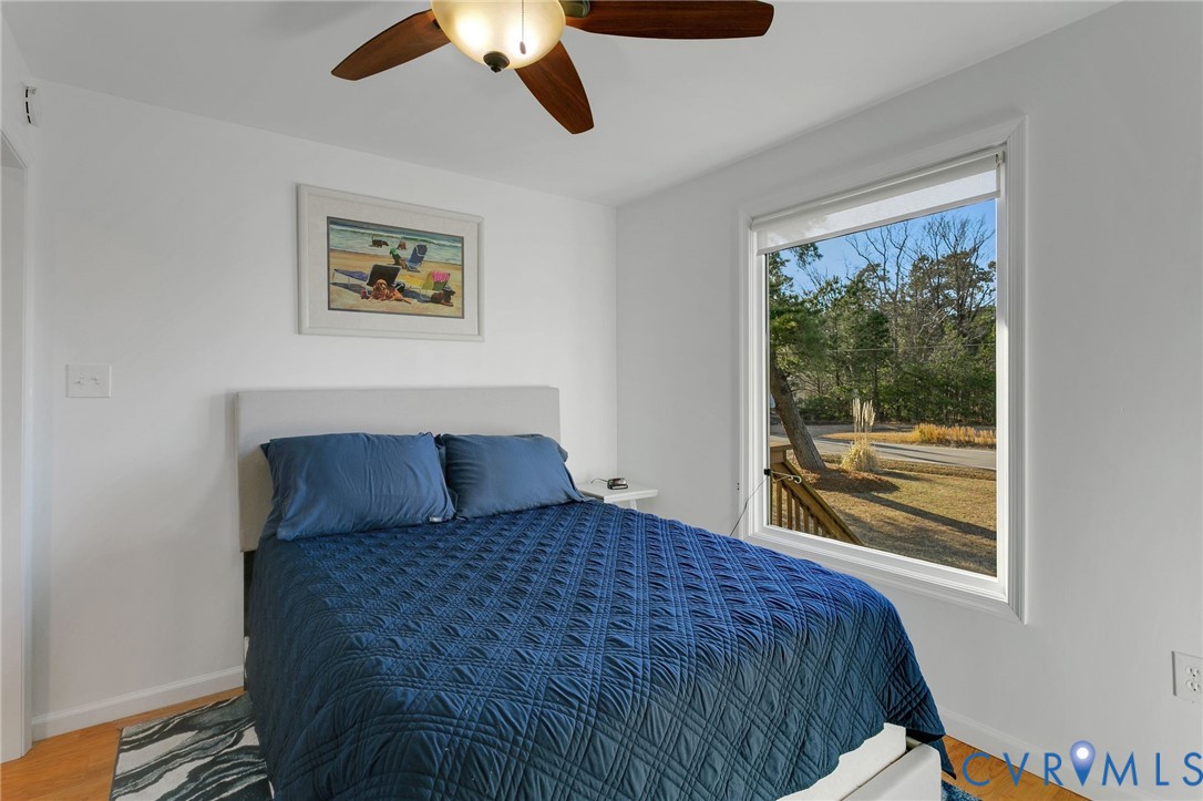 4462 Windmill Point Road White Stone, VA 22578 - Photo 19 of 29 a bedroom with a large bed and a window