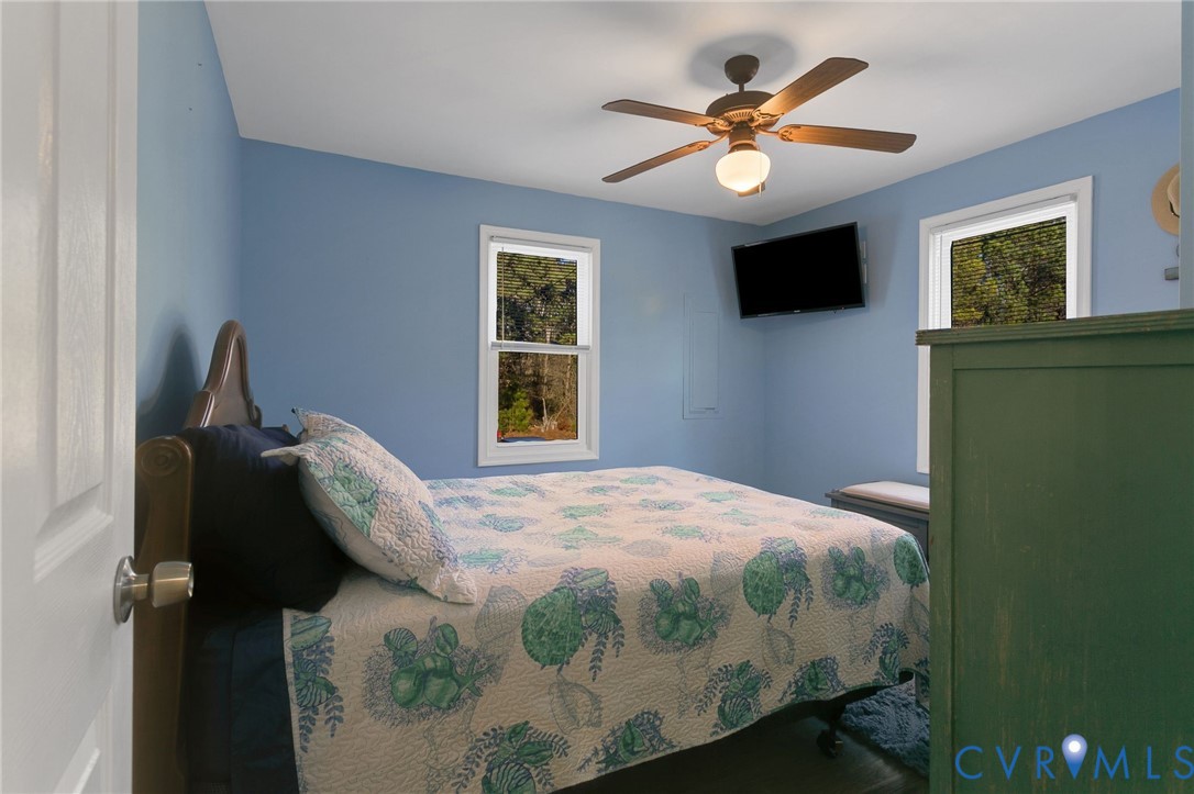 4462 Windmill Point Road White Stone, VA 22578 - Photo 20 of 29 a bedroom with a bed and a flat screen tv