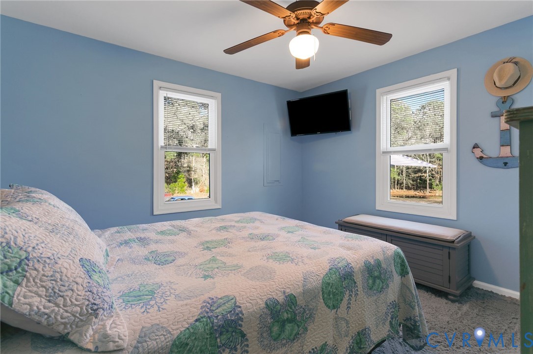 4462 Windmill Point Road White Stone, VA 22578 - Photo 21 of 29 a bedroom with a bed and a flat screen tv