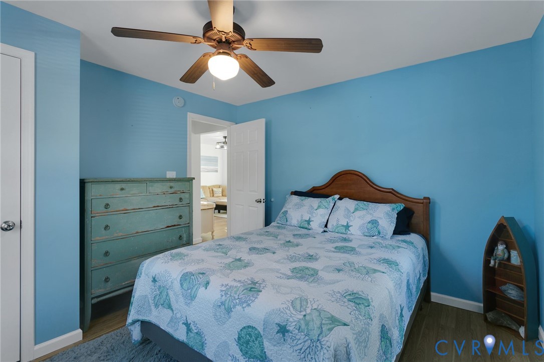 4462 Windmill Point Road White Stone, VA 22578 - Photo 22 of 29 a bedroom with a bed and a chandelier