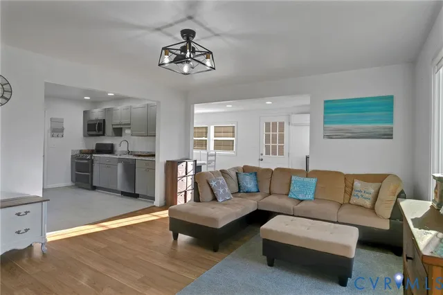 a living room with furniture and kitchen view