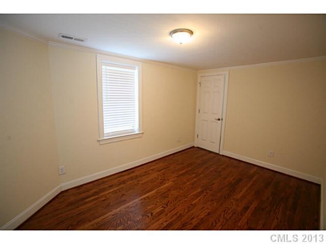 6441 Stirewalt Road Kannapolis, NC 28081 - Photo 11 of 16 a view of an empty room with wooden floor and a window