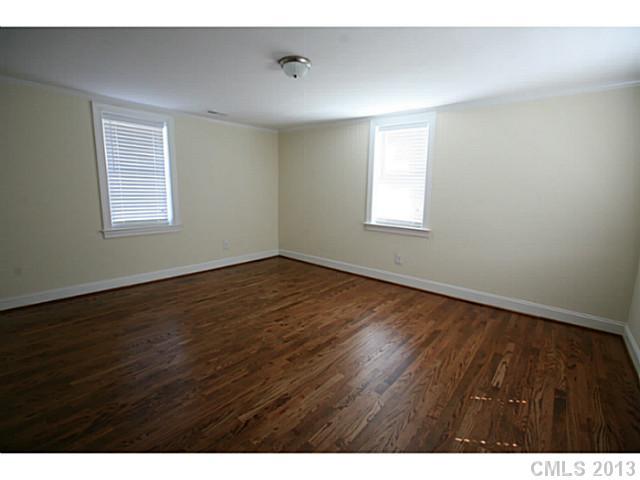 6441 Stirewalt Road Kannapolis, NC 28081 - Photo 12 of 16 a view of an empty room with wooden floor and a window
