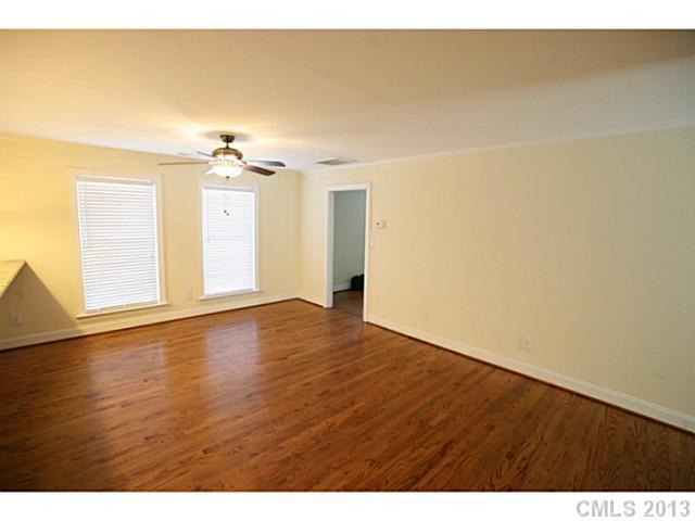 6441 Stirewalt Road Kannapolis, NC 28081 - Photo 7 of 16 a view of an empty room with wooden floor and a window