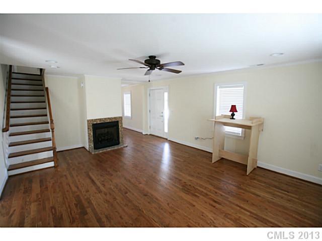 6441 Stirewalt Road Kannapolis, NC 28081 - Photo 8 of 16 a view of an empty room with wooden floor and a ceiling fan
