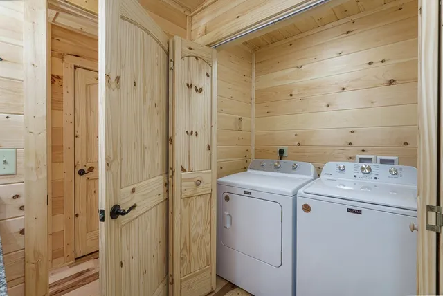 a view of hallway with a large window and wooden floor