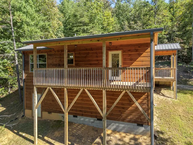 an aerial view of a house with backyard of swimming pool and outdoor seating