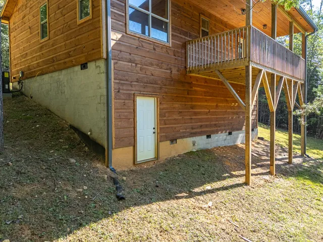 a view of a house with a yard and wooden fence