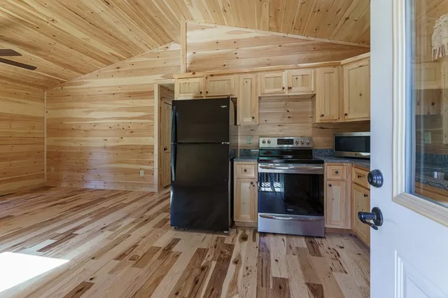 a kitchen with stainless steel appliances a refrigerator and a stove