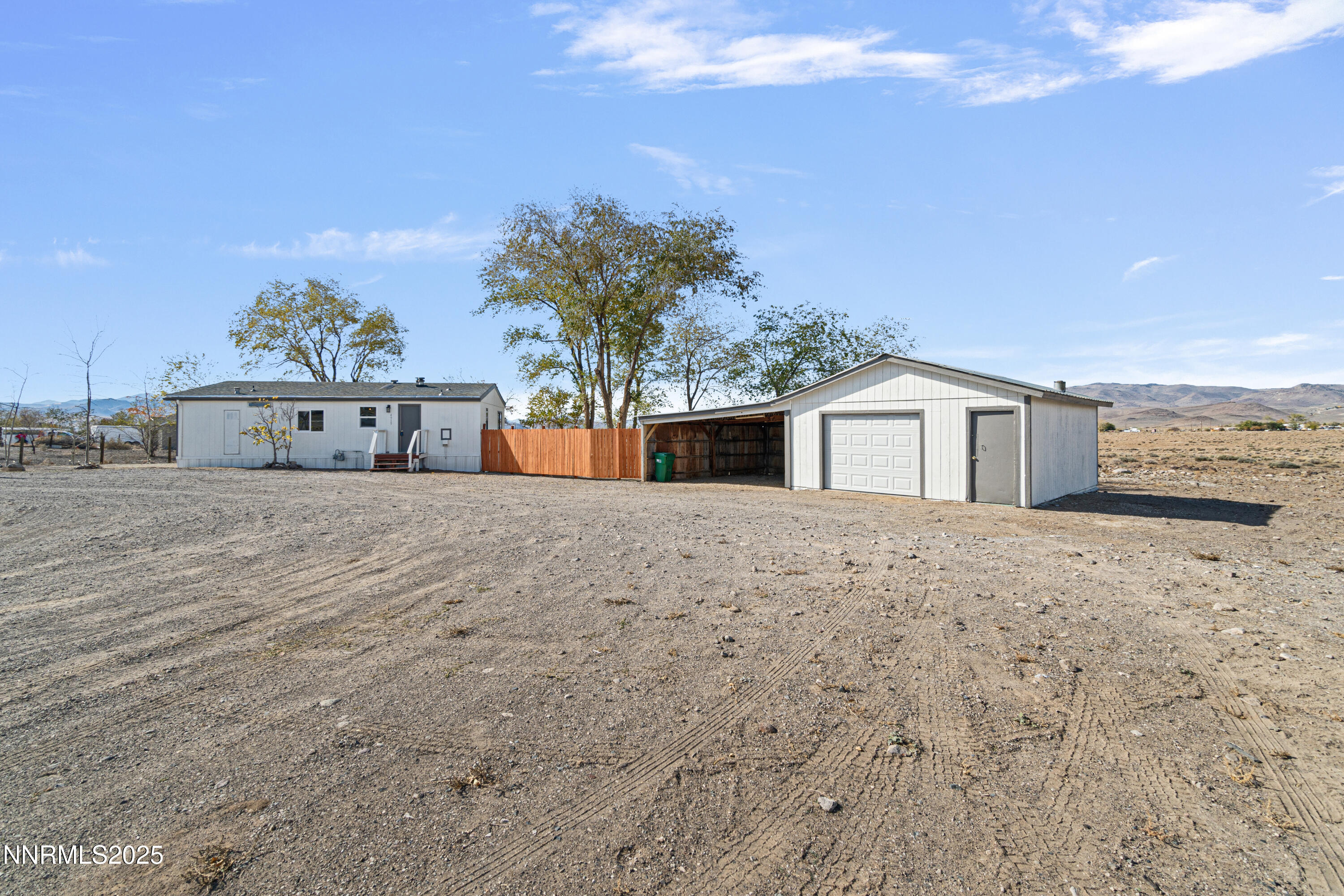 a view of a house with palm trees and a big yard