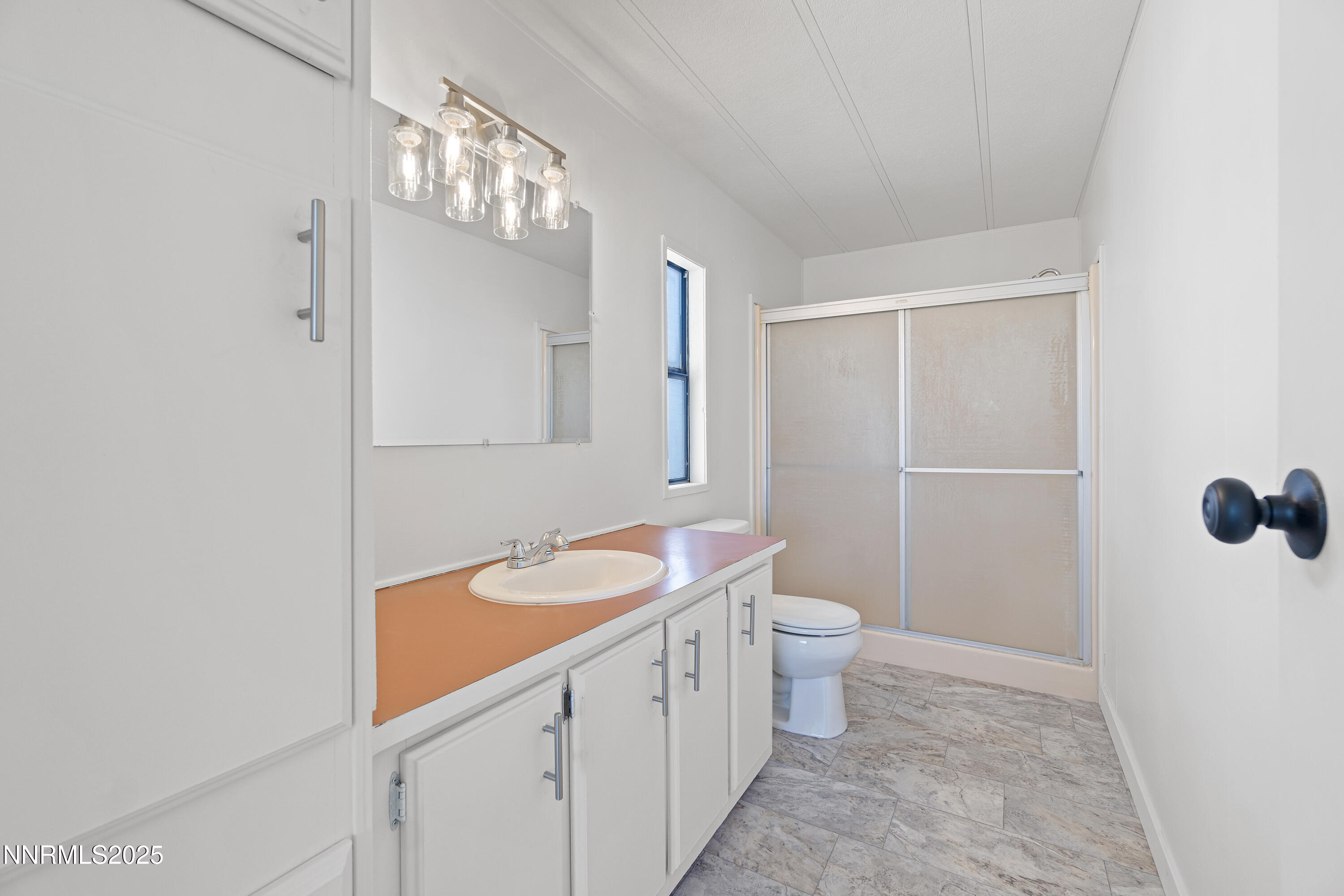 4915 Cheyenne Trail Stagecoach, NV 89429 - Photo 13 of 26 a bathroom with a sink a toilet a mirror and shower