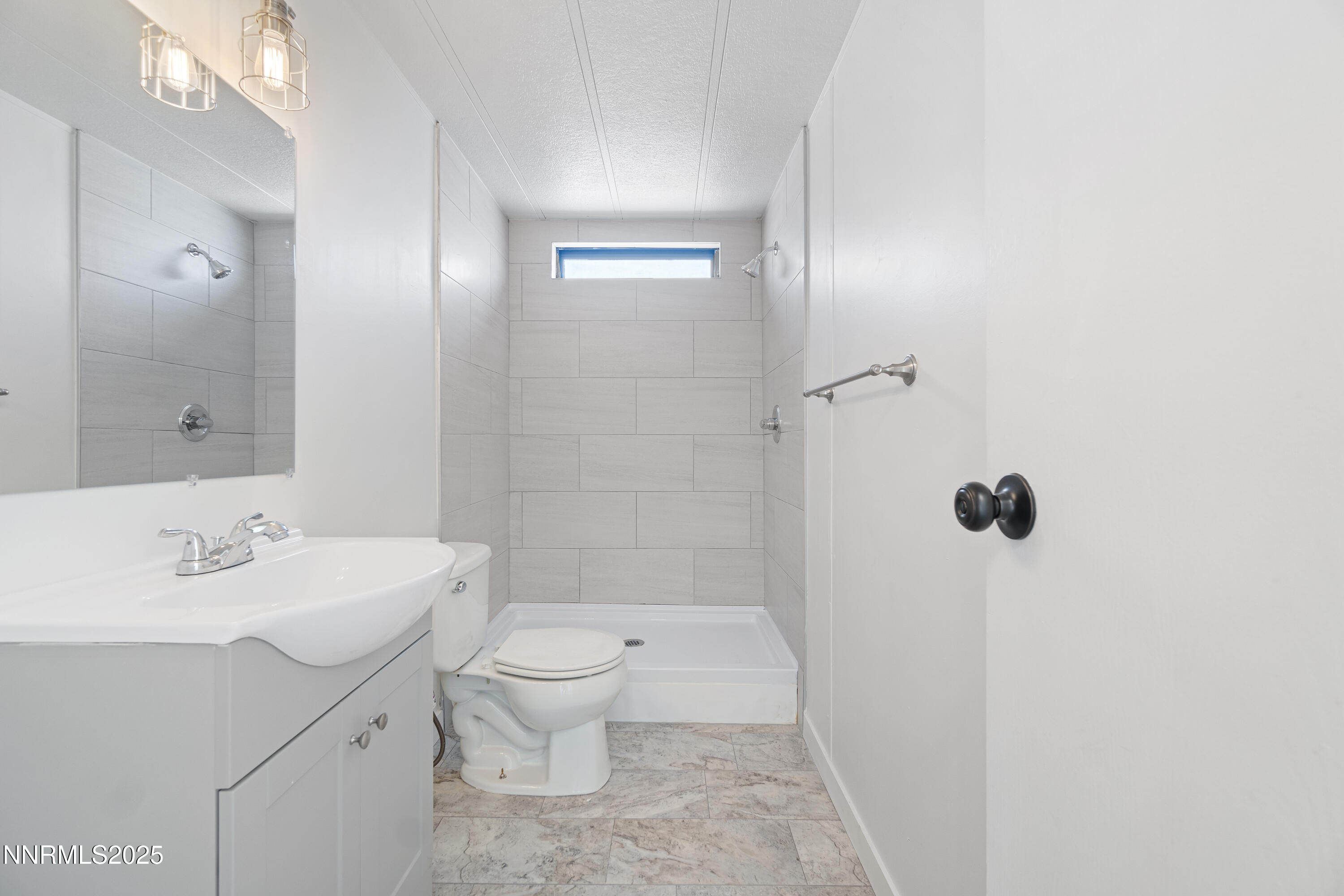 4915 Cheyenne Trail Stagecoach, NV 89429 - Photo 16 of 26 a bathroom with a sink a toilet a mirror and shower