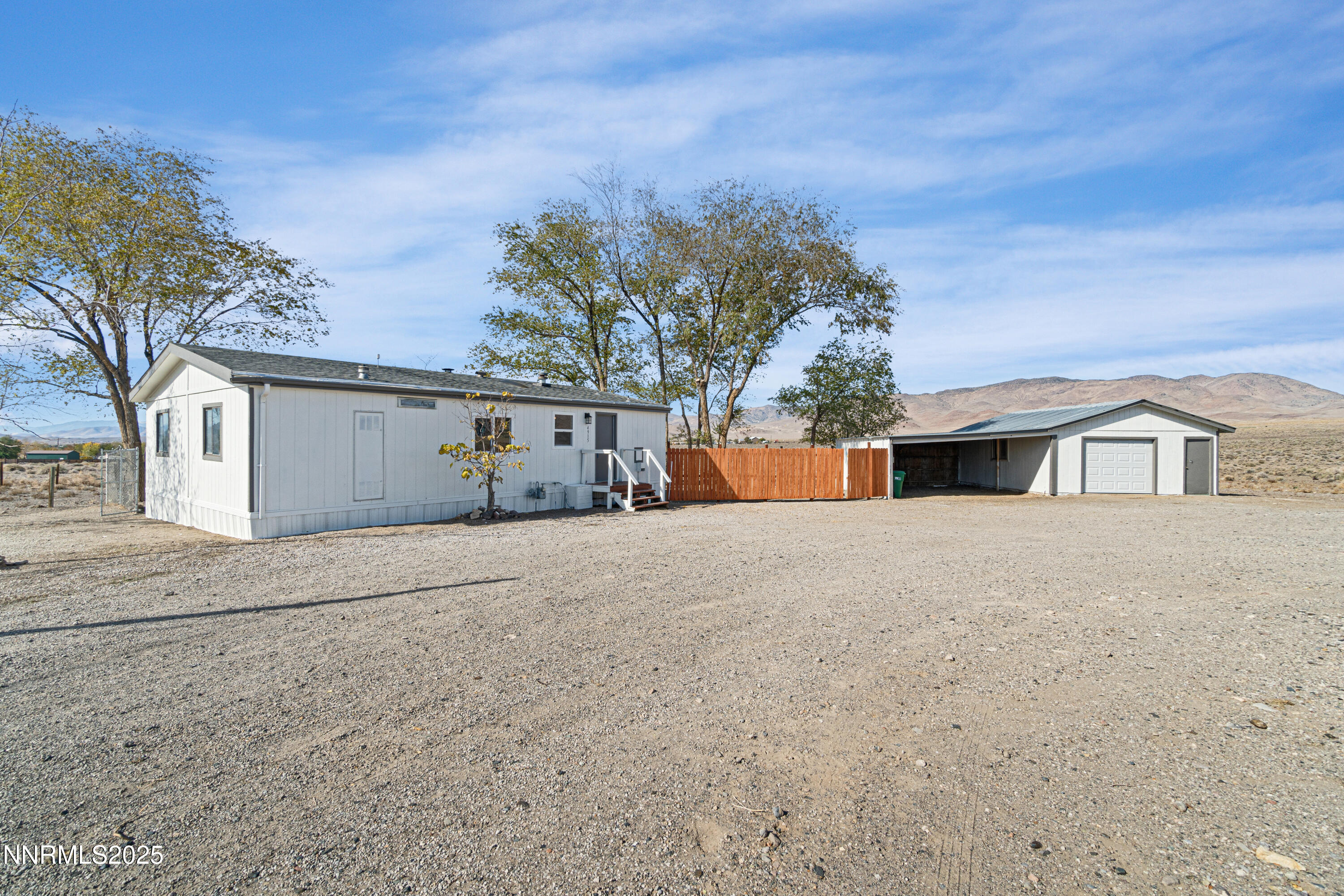 4915 Cheyenne Trail Stagecoach, NV 89429 - Photo 2 of 26 a front view of a house with a yard and garage
