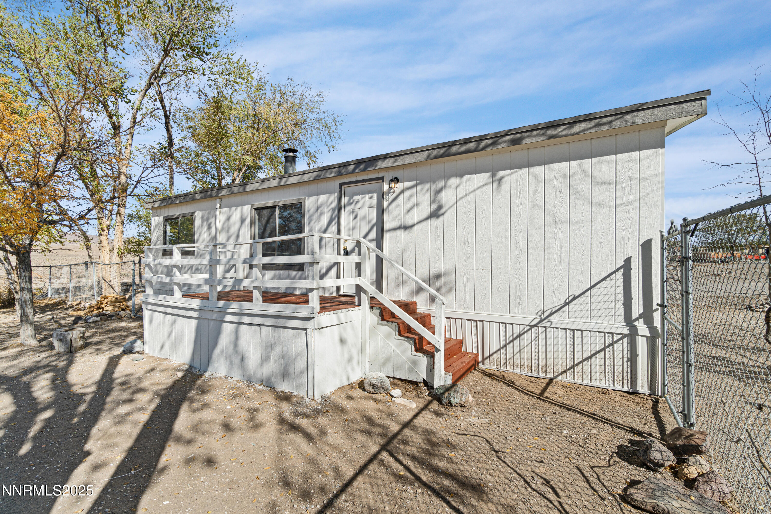 4915 Cheyenne Trail Stagecoach, NV 89429 - Photo 21 of 26 a view of a balcony with dining table and chairs with wooden floor and fence