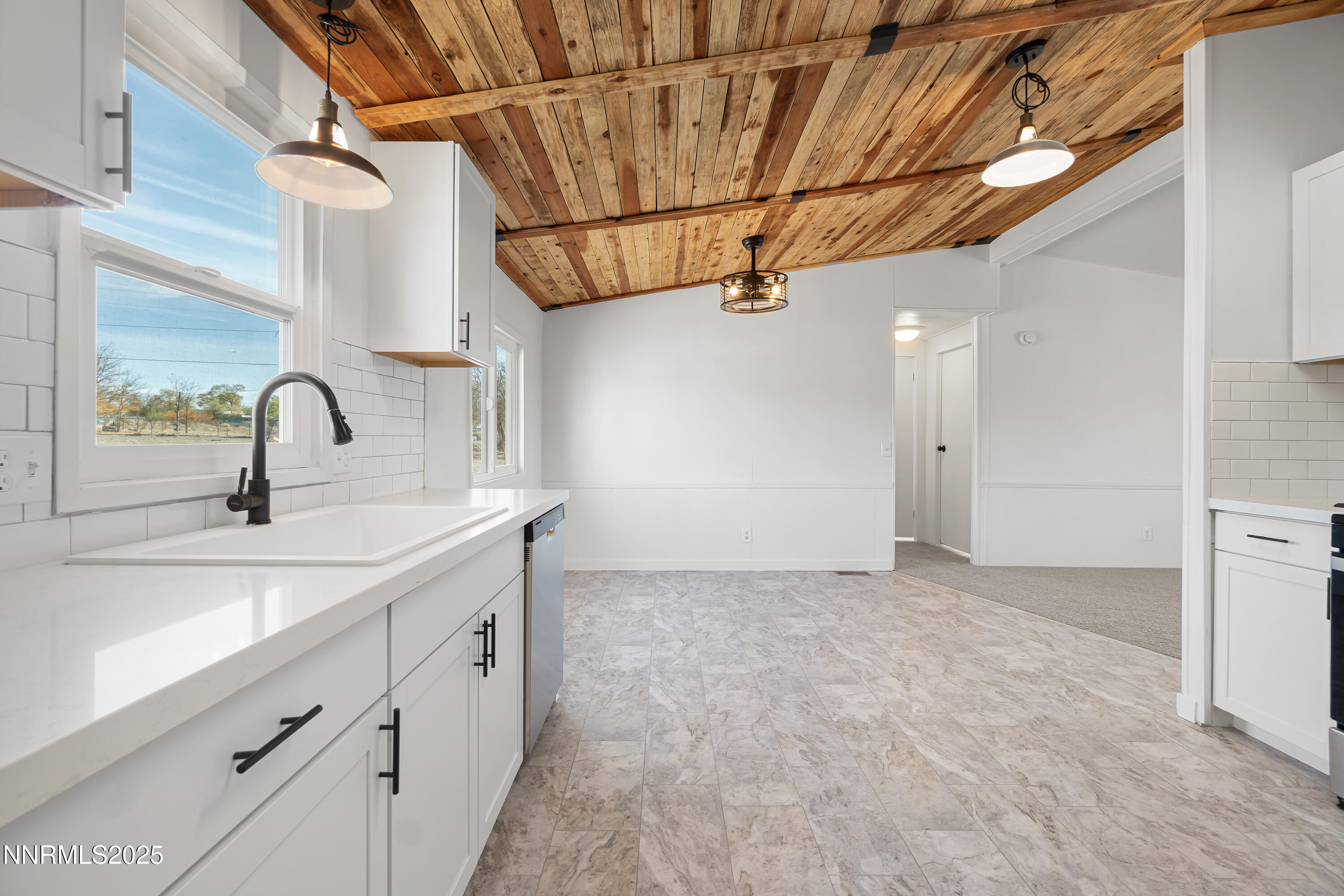 4915 Cheyenne Trail Stagecoach, NV 89429 - Photo 5 of 26 a kitchen with stainless steel appliances a sink and cabinets