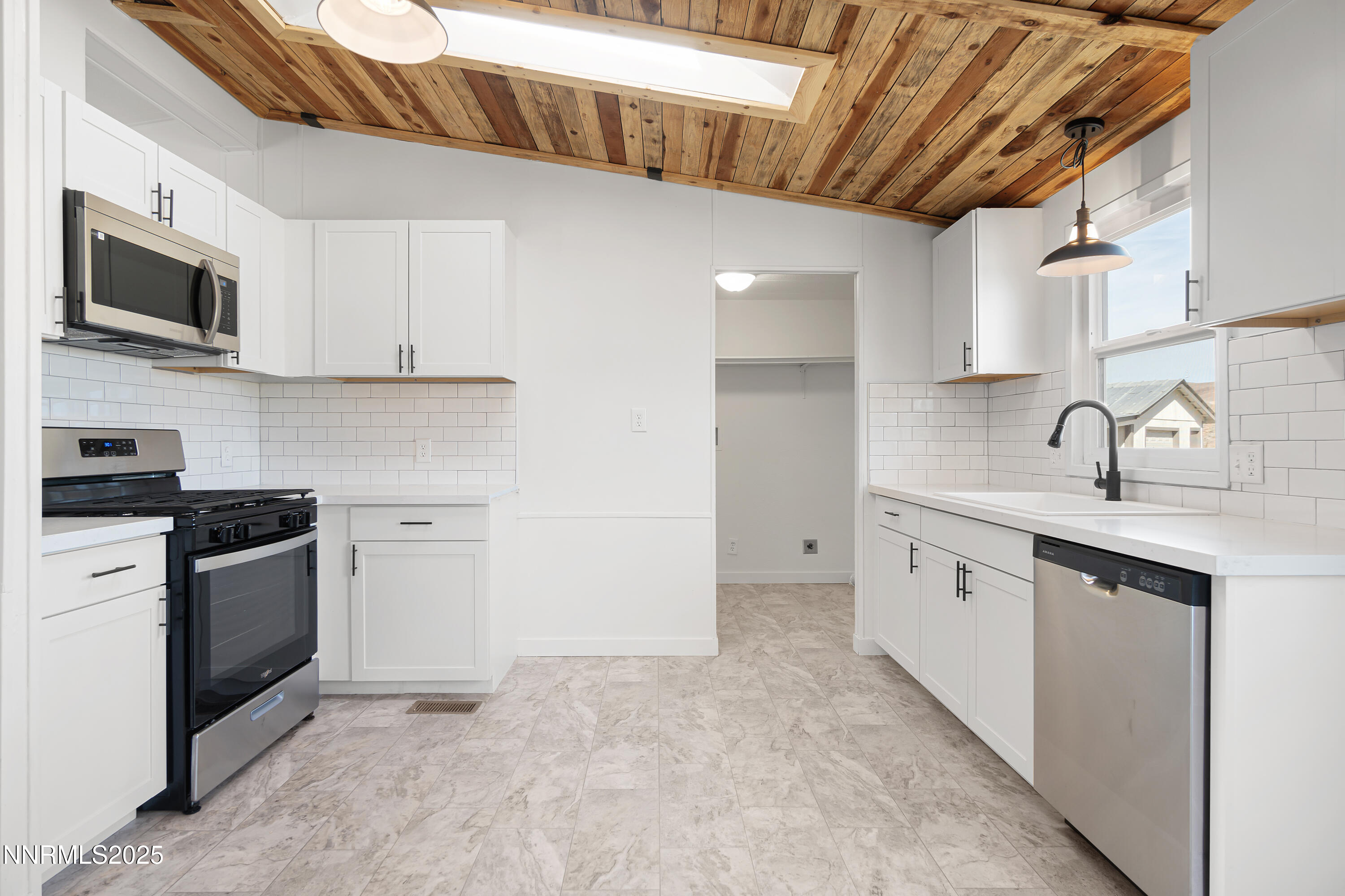 4915 Cheyenne Trail Stagecoach, NV 89429 - Photo 6 of 26 a kitchen with stainless steel appliances granite countertop a sink and a stove top oven