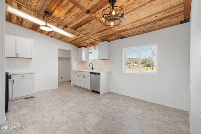 a view of a storage & utility room with wooden shelves