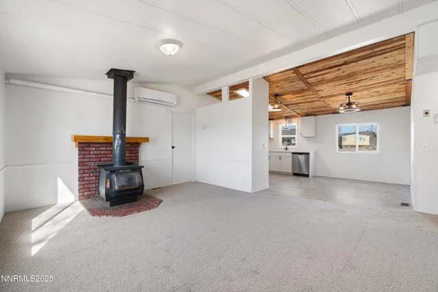 a view of a livingroom with furniture and a fireplace