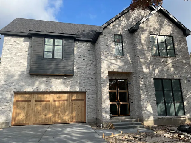 a front view of a house with garage