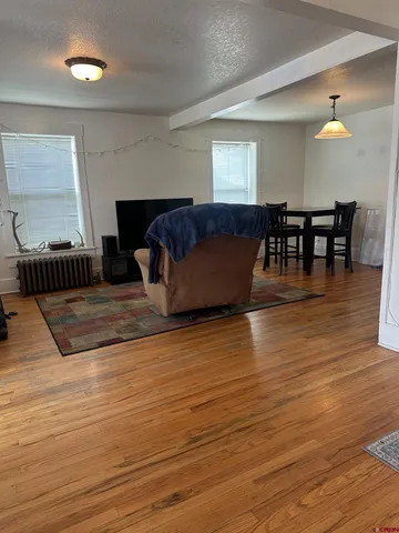 a living room with furniture and wooden floor
