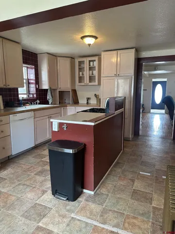 a kitchen with a stove sink and cabinets