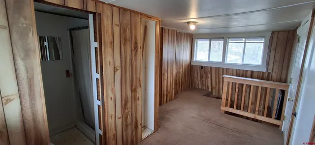a view of a hallway with windows and stairs