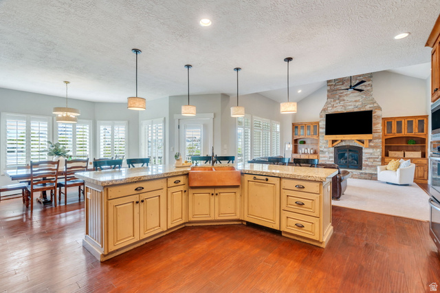 1355 West 1000 South Mapleton, UT 84664 - Photo 74 of 74 Kitchen with open floor plan, pendant lighting, a fireplace, an island with sink, and light stone countertops
