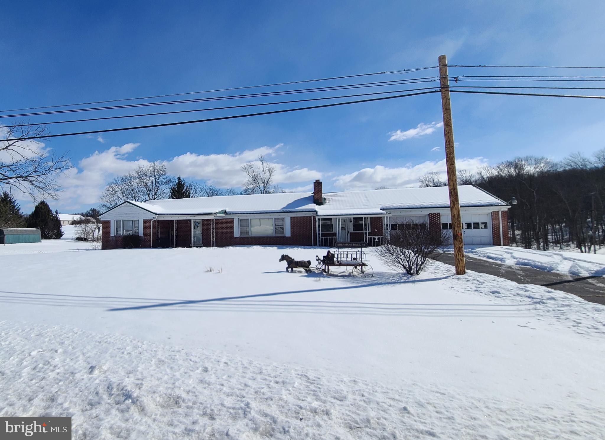 Charming home nestled in a snowy landscape.