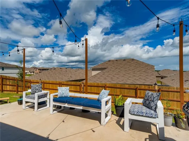 a roof deck with a table and chairs