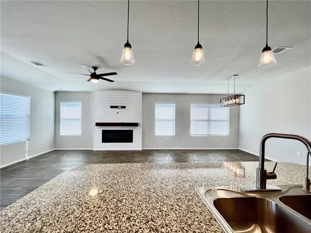 a kitchen with stainless steel appliances granite countertop a sink a refrigerator and a stove