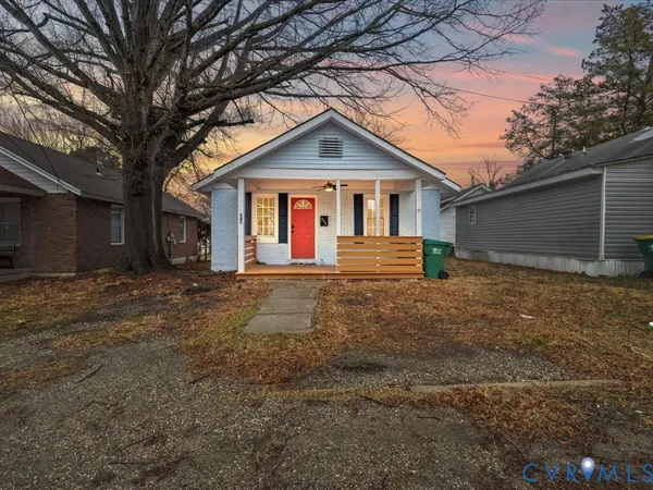 a front view of house with yard and trees