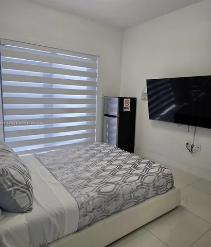 a bedroom with bed painting on wall and wall painting