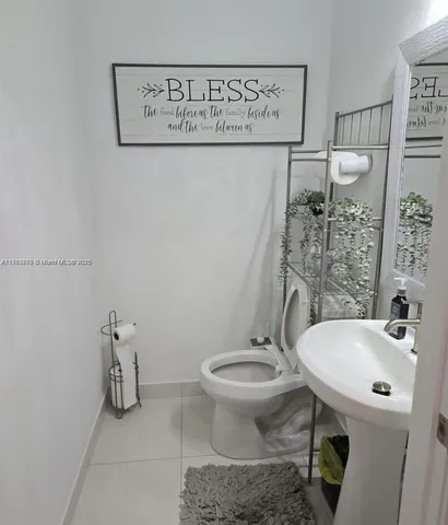 a bedroom with a bed and two windows