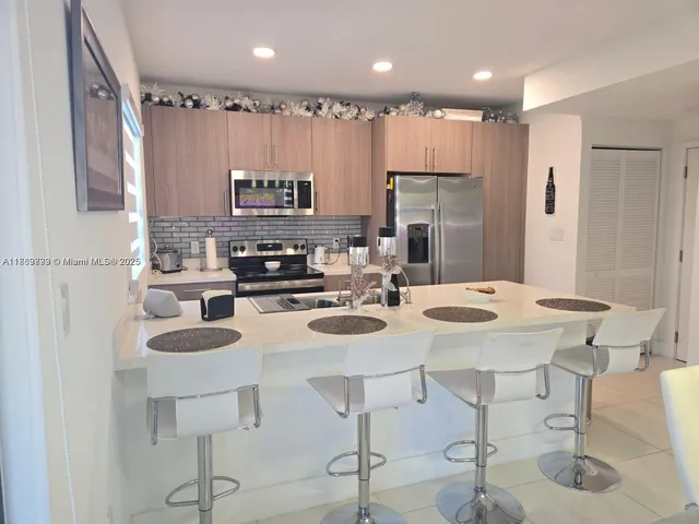 a view of a kitchen with a sink and cabinets
