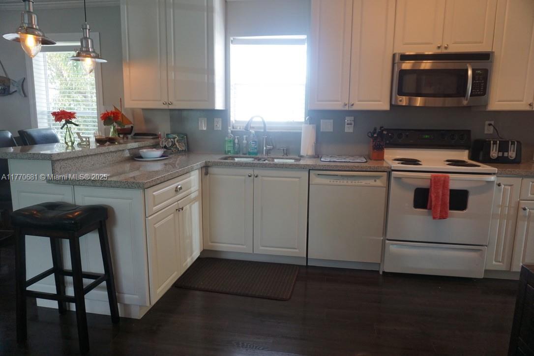 11 Old State Road Key Largo, FL 33037 - Photo 28 of 100 a kitchen with a stove a sink and a microwave