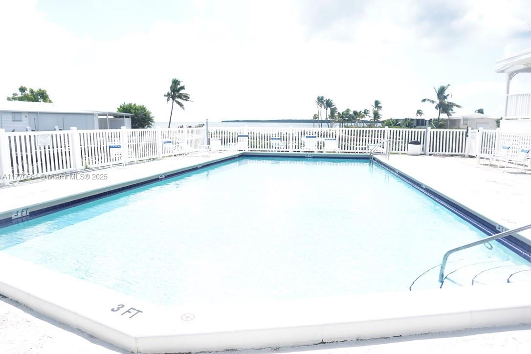 11 Old State Road Key Largo, FL 33037 - Photo 3 of 100 a view of a swimming pool with an ocean view