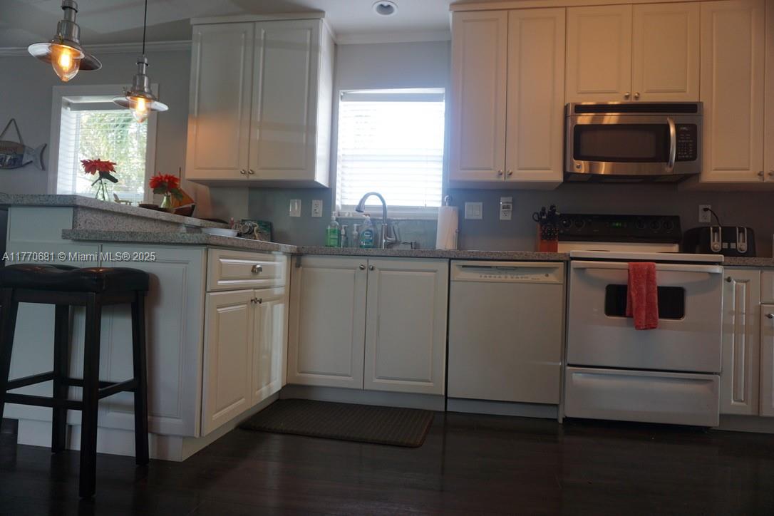 11 Old State Road Key Largo, FL 33037 - Photo 33 of 100 a kitchen with granite countertop cabinets stainless steel appliances and a sink